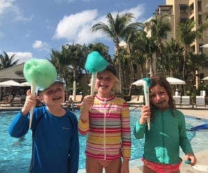 Three kids holding cotton candy near pool at Ritz Carlton Grand Cayman