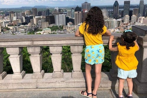 Montreal Vacation Kids, Sisters dressed in yellow looking out during Montreal vacation