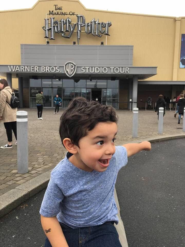 A young boy outside the entrance to Harry Potter Studios in London.