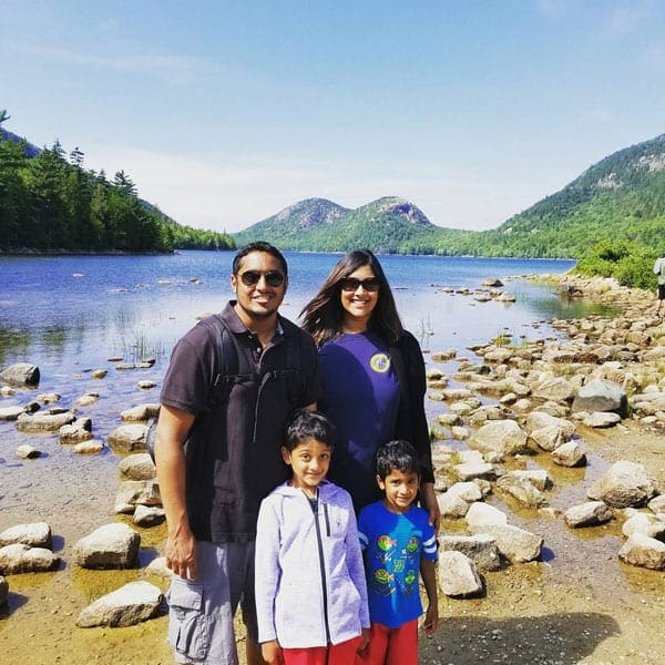 Family of 4 posing for picture at Acadia National Park