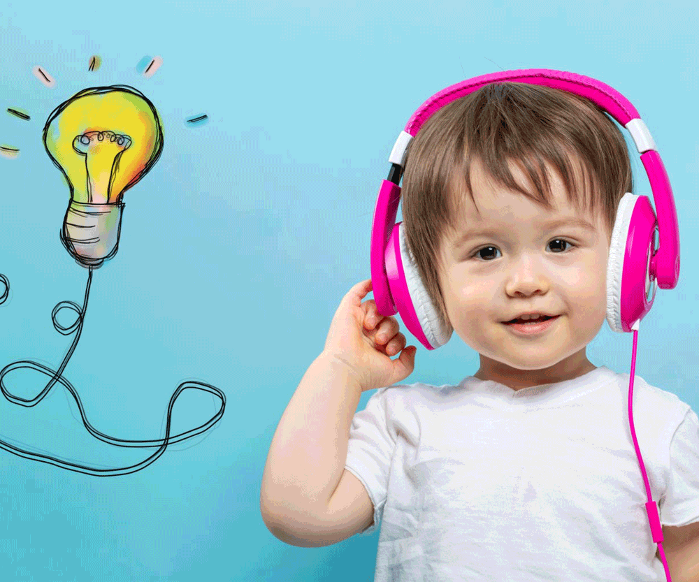 Baby in white shirt with purple headphones and light bulb graphic.
