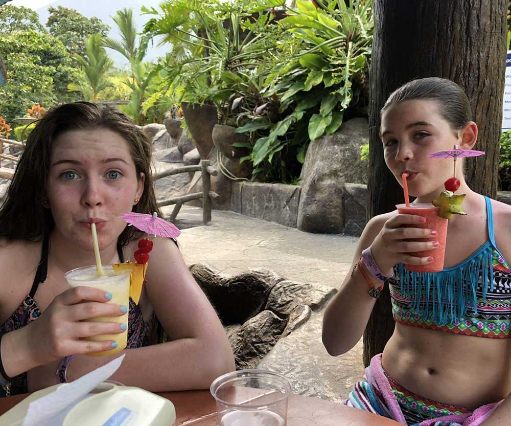 Two teenagers sipping on a drink in Costa Rica.
