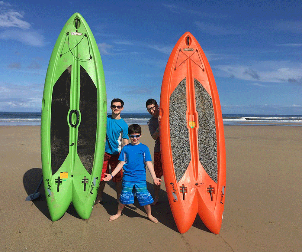 3 kids holding surf 2 board in green and orange color