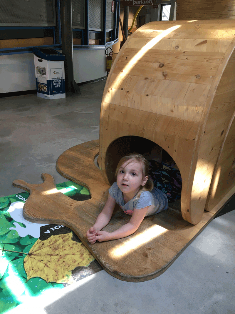 Girl playing in wooden structure in museum in Explora Children's Museum, one of the best things to do in Rome with toddlers.