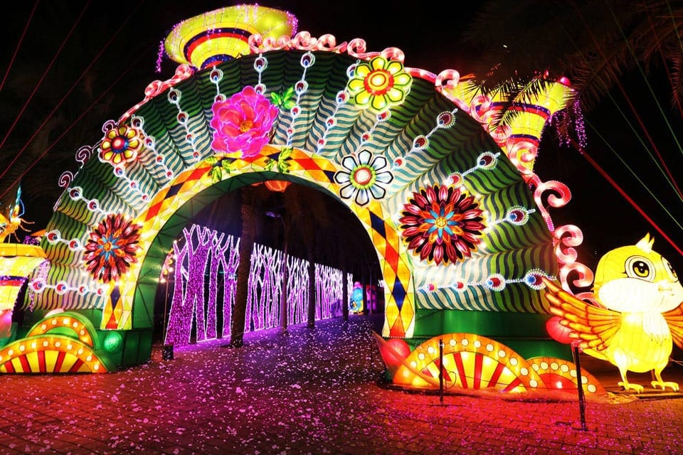 A colorful, glowing exhibit inside Dubai Garden Glow at night.