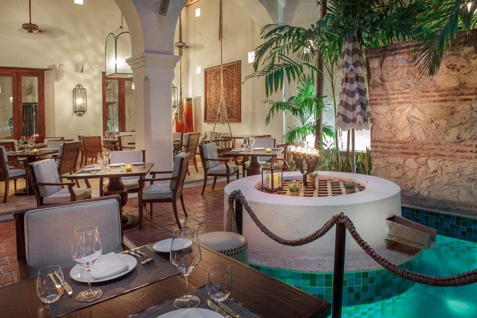 Inside the restaurant at the Hotel Casa San Agustín, featuring Colombian-style tables and styling.