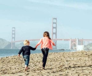 Kids running in front of golden gate bridge in San Francisco