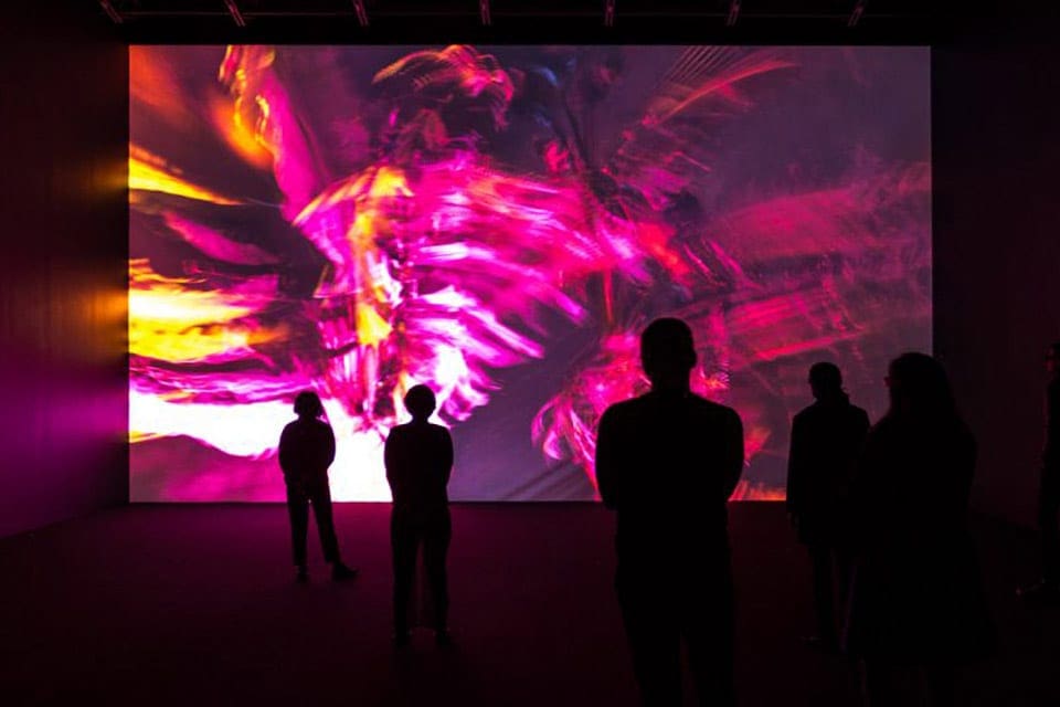 Several shadowed figures look on at an art installation at the Musée d’art Contemporain de Montréal.