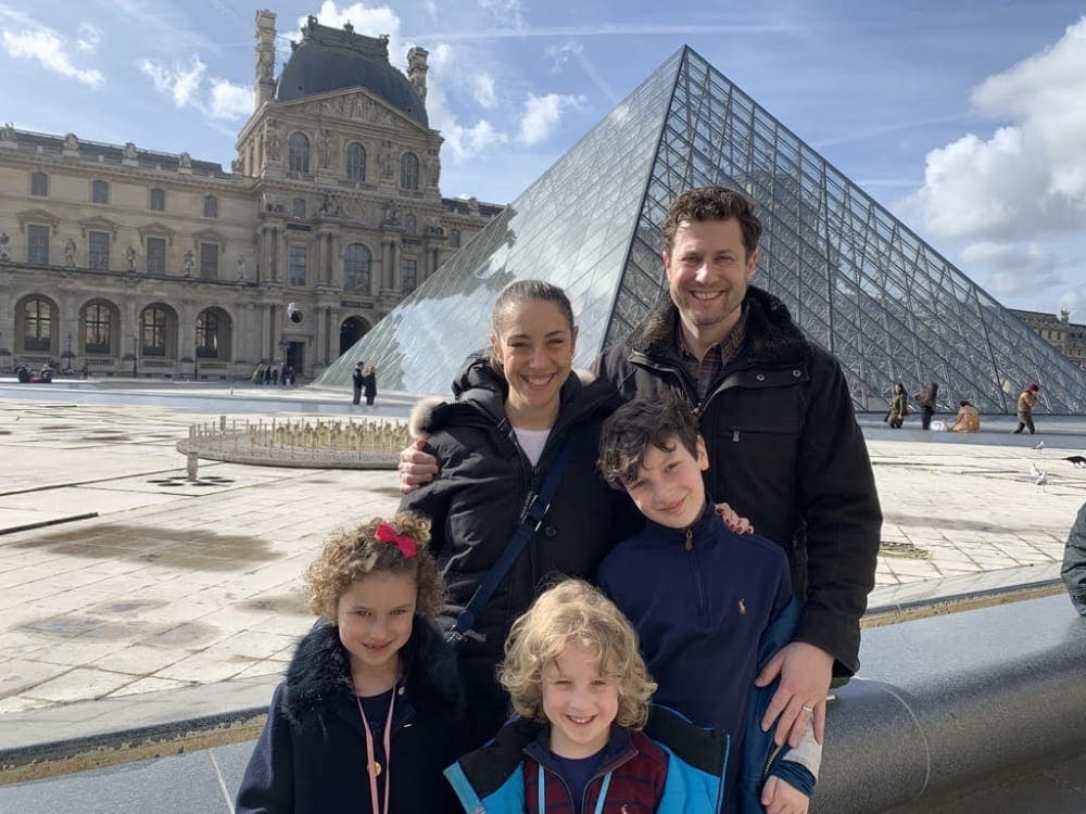 Stephanie and her family outside the Louvre in Paris