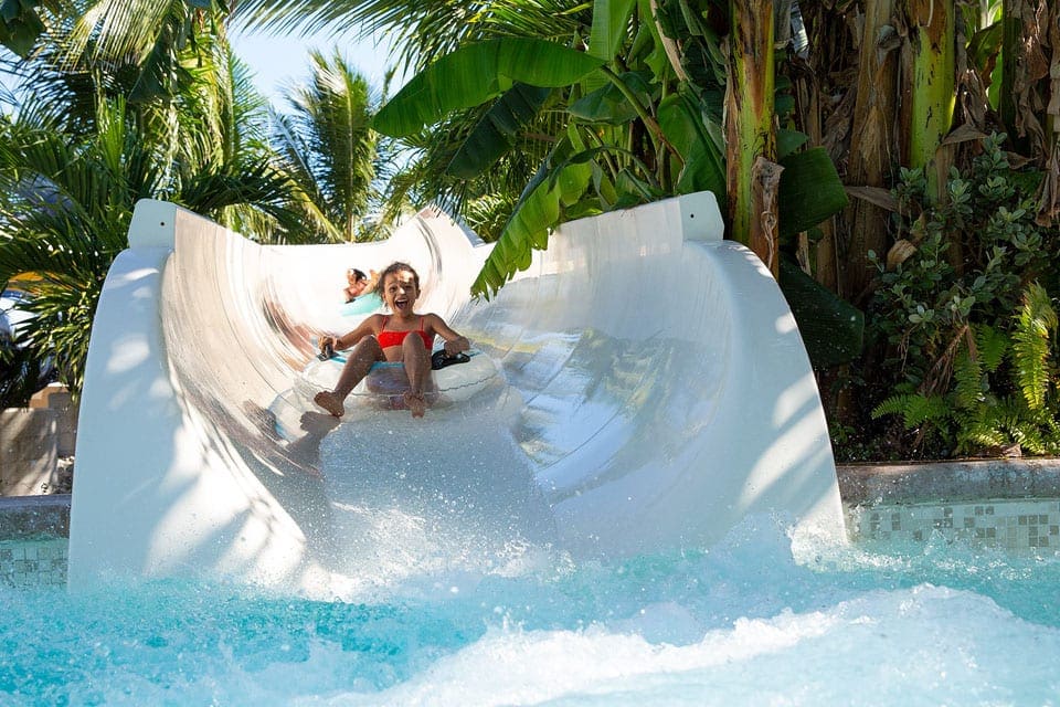 A child going down the water slide at Beaches Turks & Caicos, one of the best hotels in the Caribbean with a water park for families.