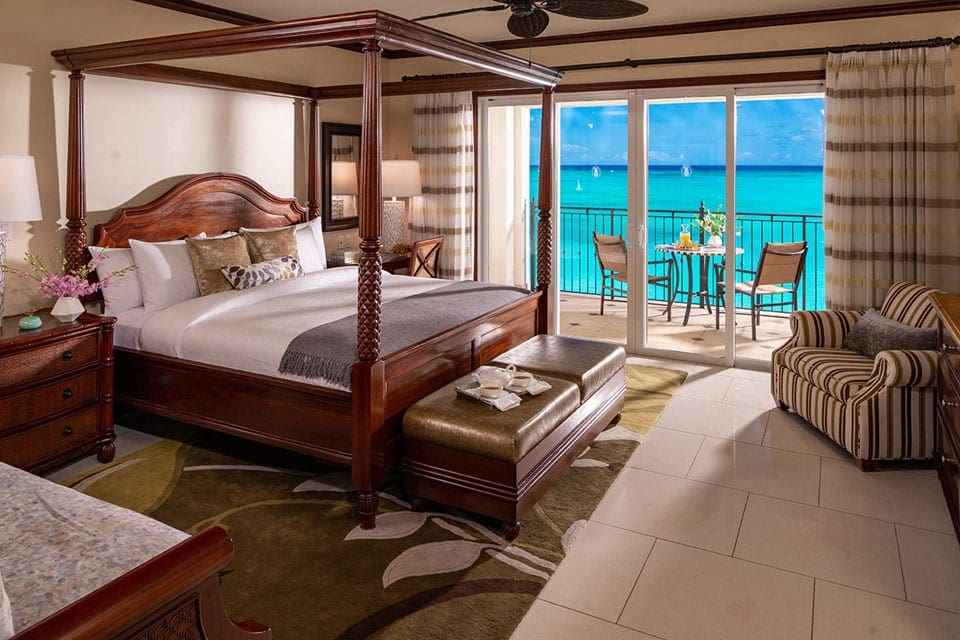 Inside one of the guest rooms at Beaches® Turks & Caicos Resort, with a view through the balcony to the ocean.