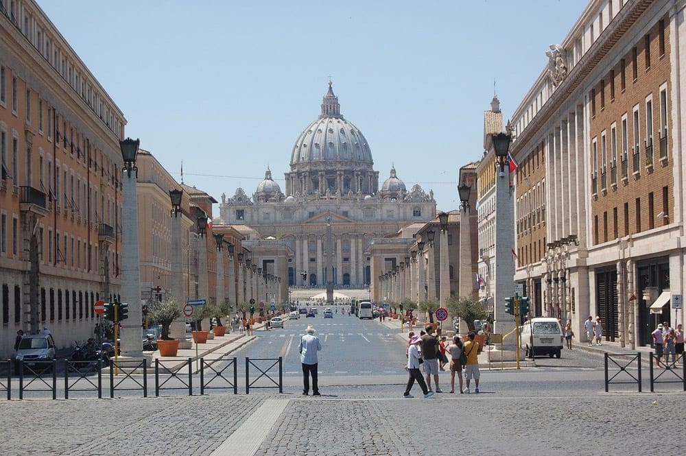 The Vatican in Rome surrounded by pedestrians.  It's one of the best places to visit on an Italy itinerary with kids. 