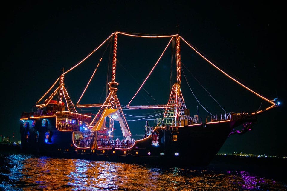 A large pirate ship decorated with lights as part of the Captain Hook thematic pirate dinner in Cancun.