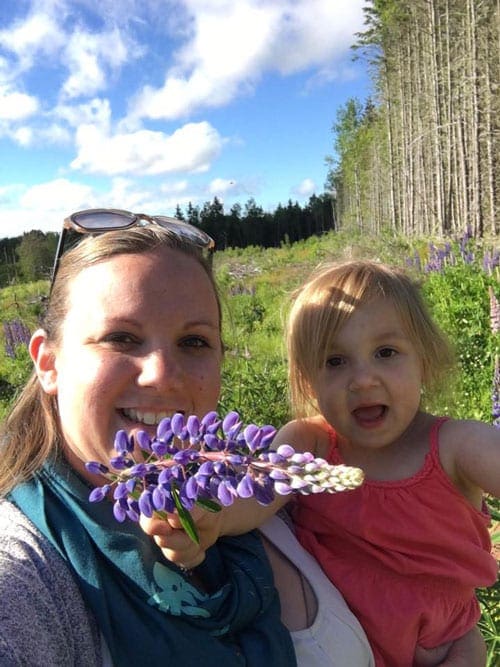 mother and daughter in flower field on Prince Edward Island