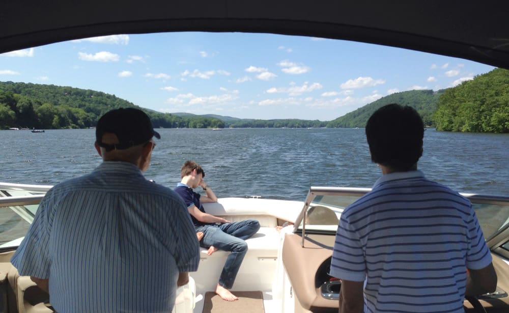 Three men on boat on Candlewood Lake in Connecticut.