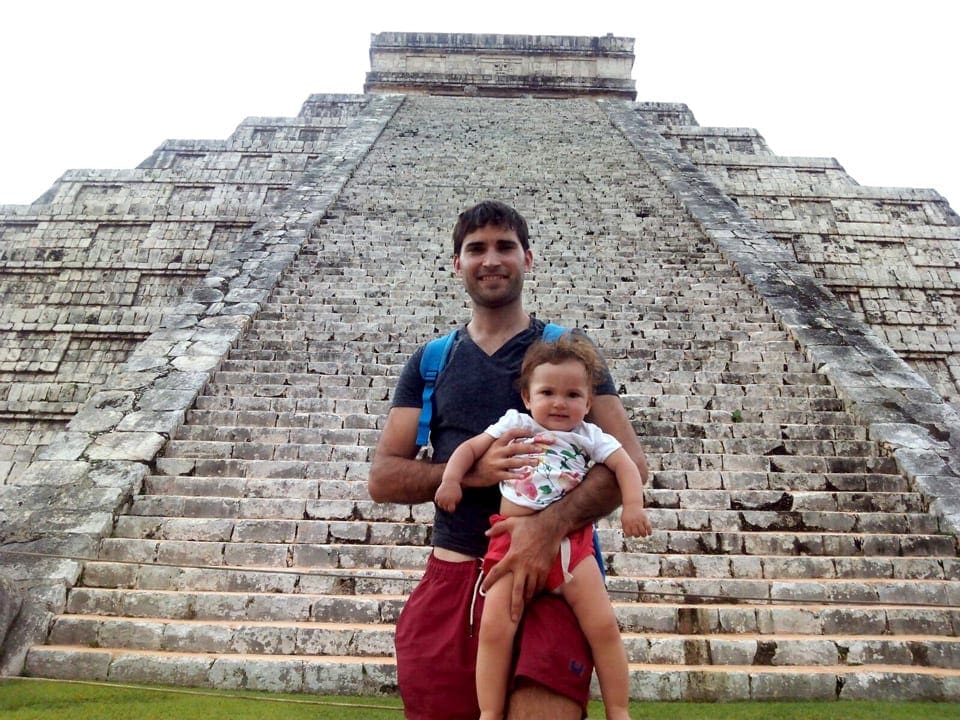Man and child in front of Mayan temple in Mexico, one of the stops on this virtual vacation to Mexico.