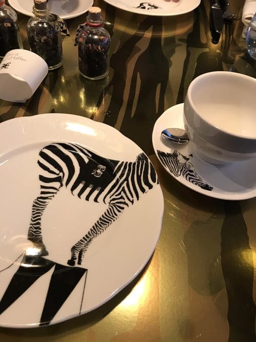 A tea cup and plate decorated like a zebra at Mad Hatter Tea Party in London.