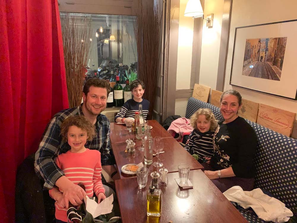 A family enjoys a restaurant in Paris