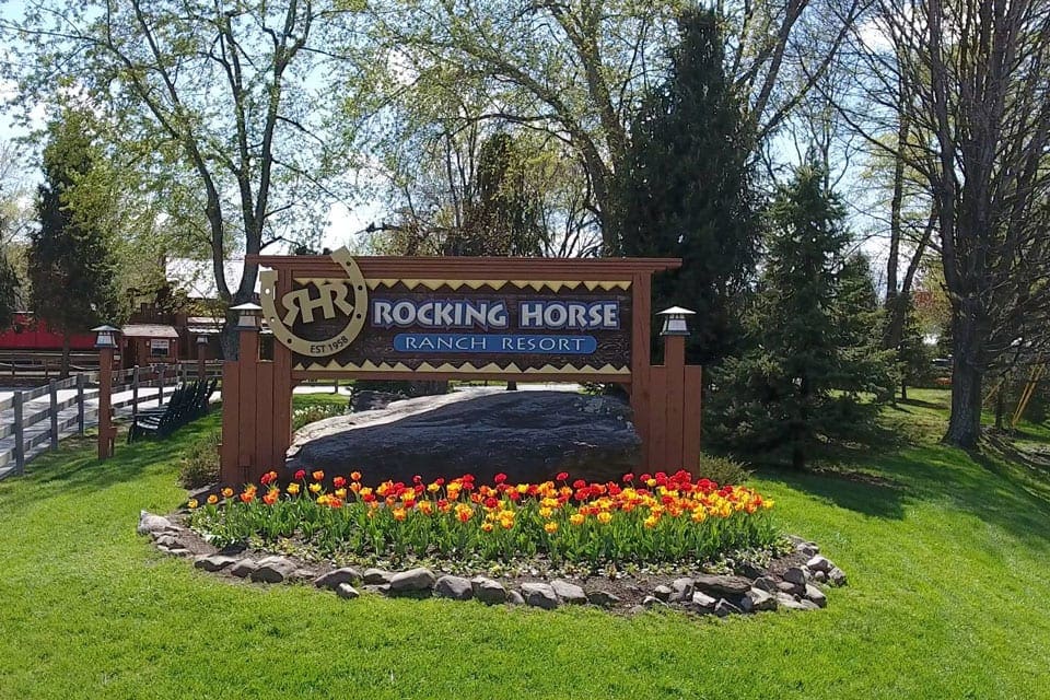 Welcome sign with tulips at the Rocking Horse Ranch