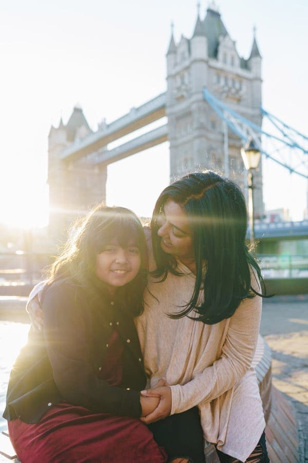 mother and daughter in front of tower bridge in London