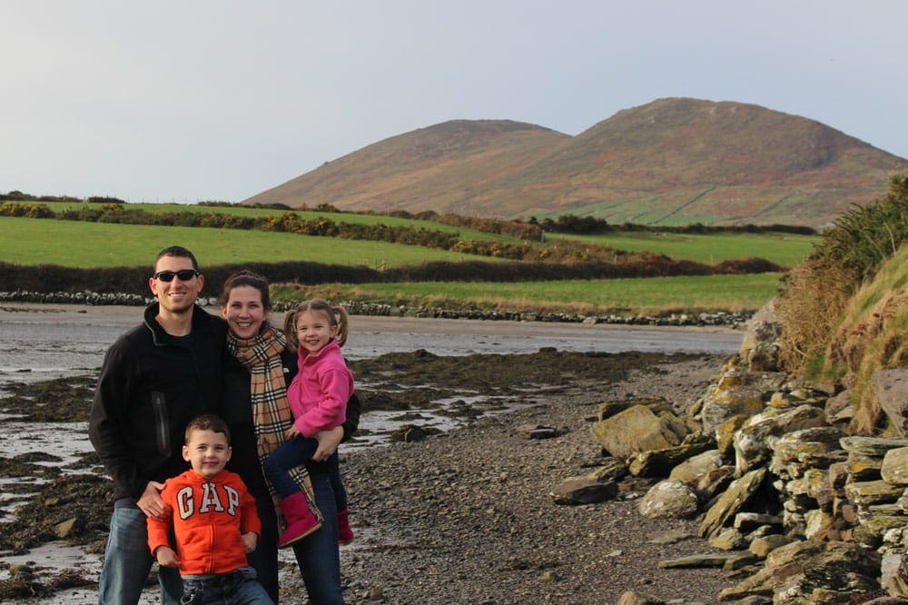 A family of four stands smiling along a beach in Ireland. Thus ends our virtual vacation to Ireland.