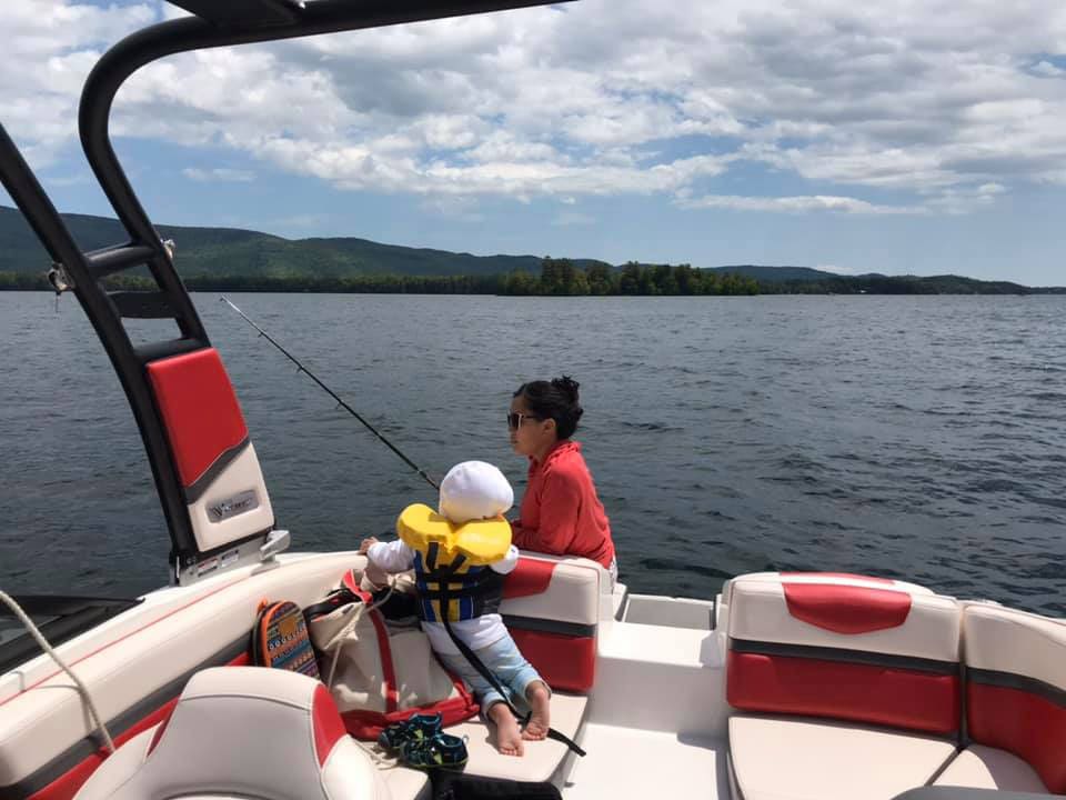 Mother and son fishing on boat in Lake George.