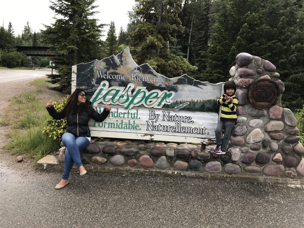 Mom and son in front of Banff National Park sign