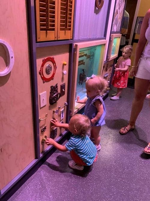 Two small kids play in an exhibit at the American History Museum in Washington D.C.