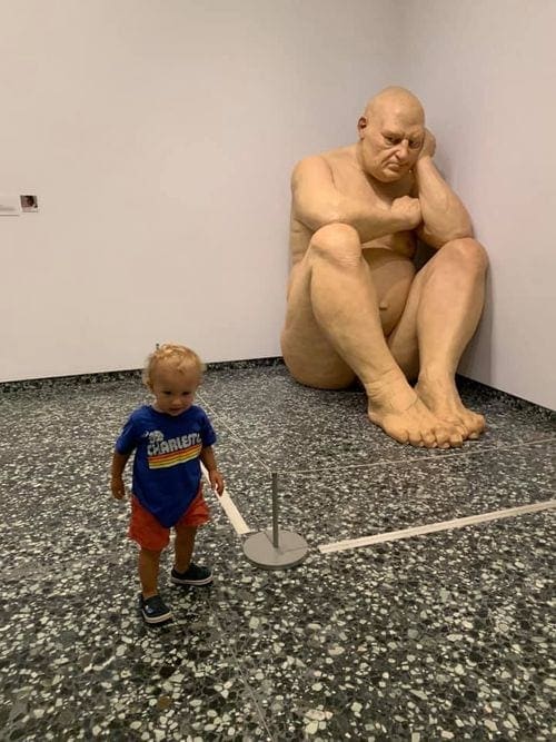 Toddler boy explores a statue at the Hirshhorn Museum in Washington D.C.