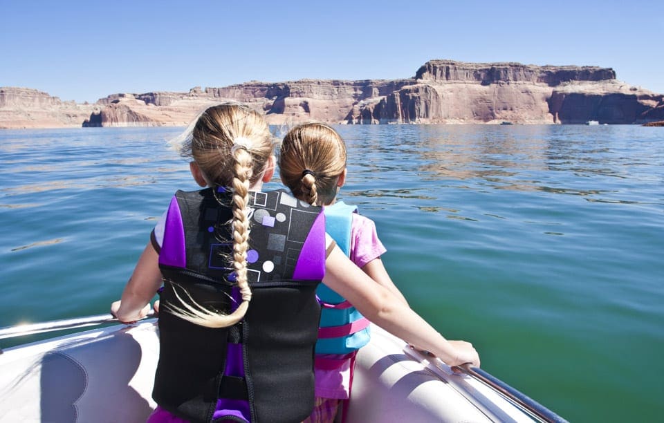 Two girls at the bow of a boat on Lake Powell.