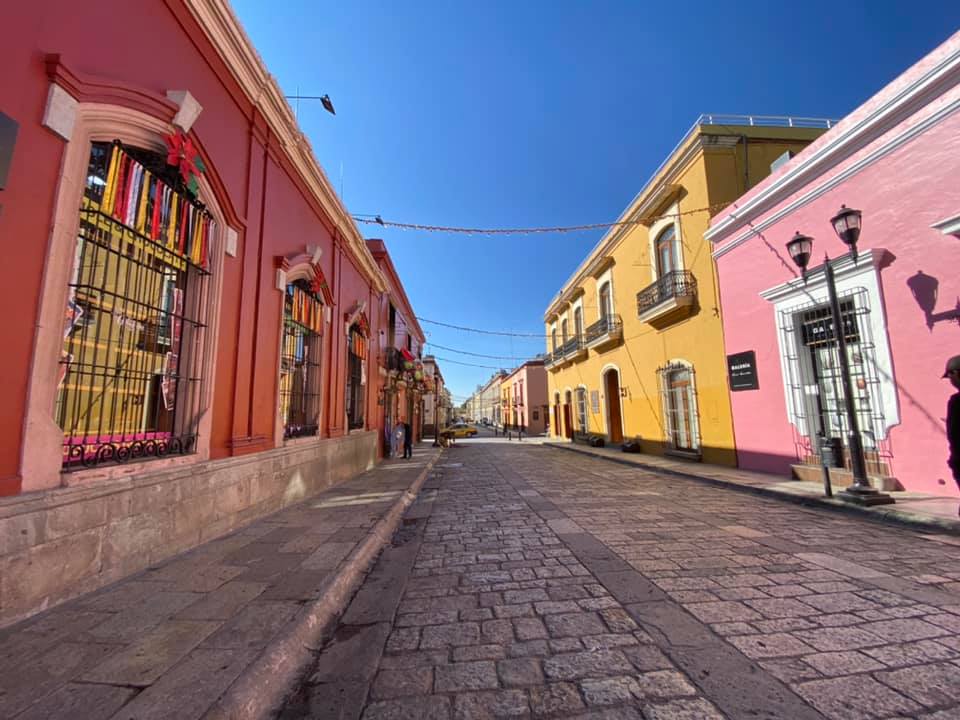 Best Colorful Towns For Families. Empty, but very colorful street in Oaxaca, Mexico.