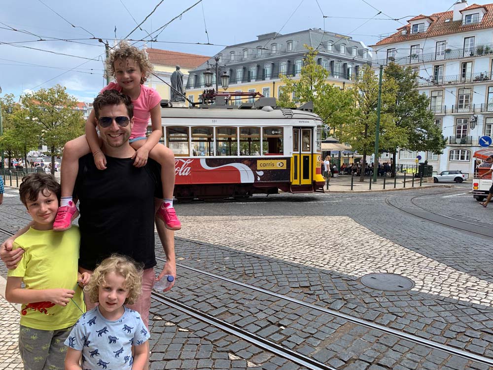 Portugal Lisbon trolley dad kids on shoulder and next to him