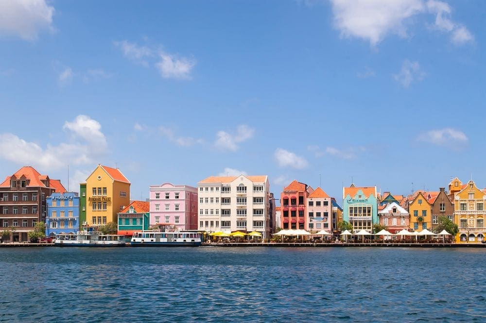 Colorful homes on the beach in Willemstad, Curacao, one of the best Caribbean islands for families.