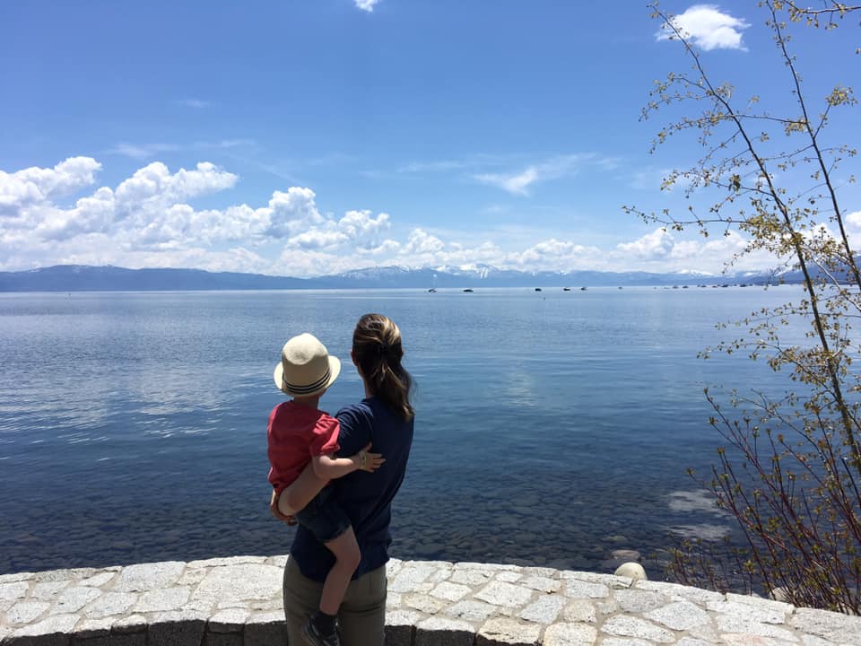 Mother and son from the back looking at Lake Tahoe in summer on vacation