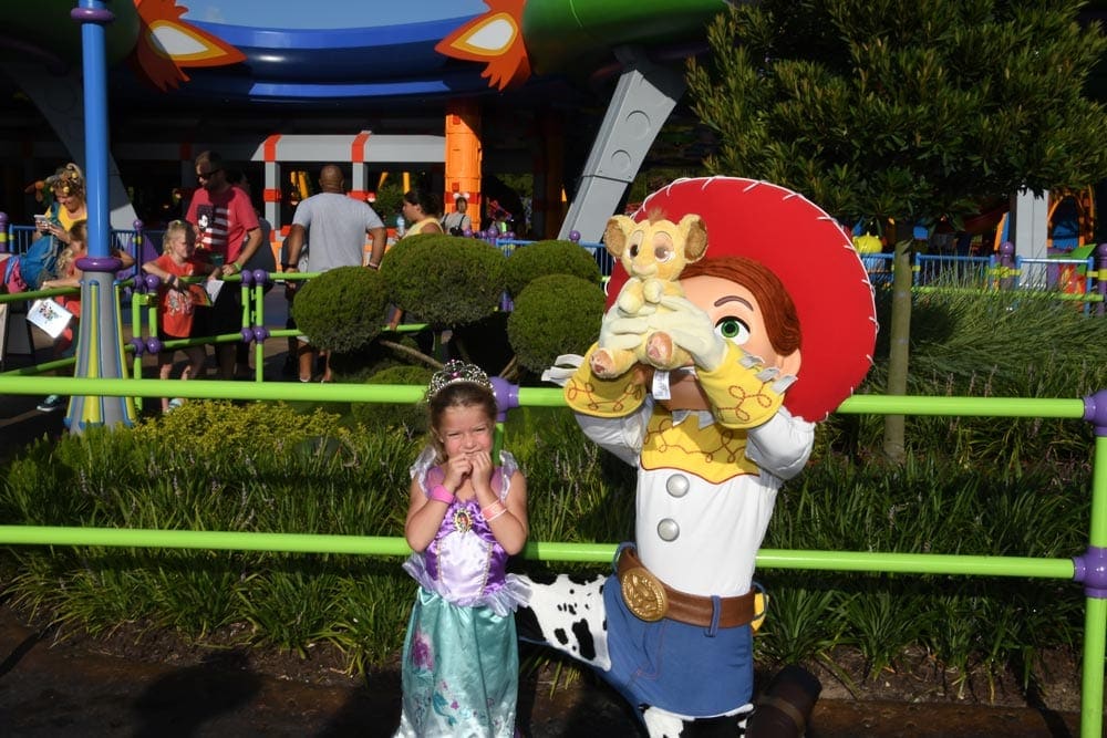 Girl in princess dress at Disney World with Toy Story character. Disney World Kids multi-trip itinerary. 