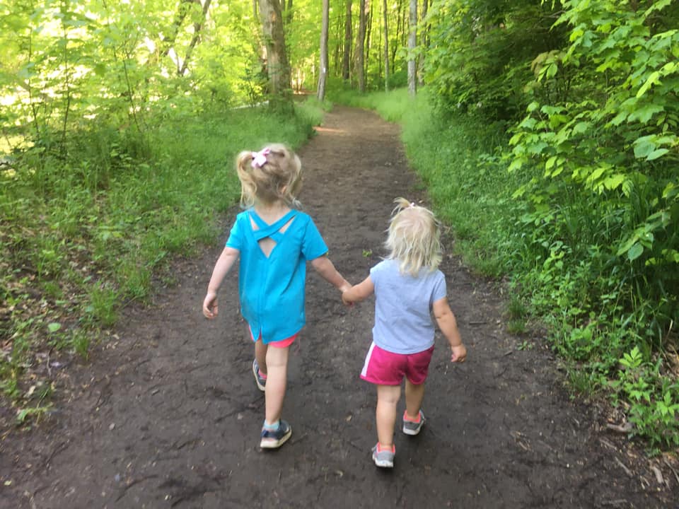 Two little girls holding hands and walking, 10 Best Midwest State Parks For Families