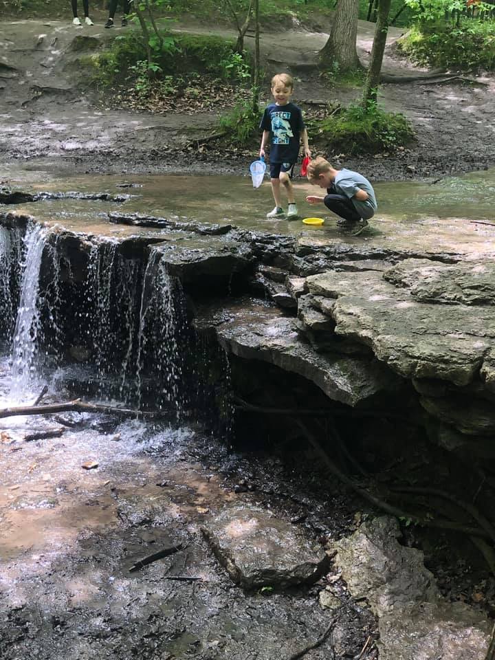 Kids playing near a waterfall at Platte River State Park