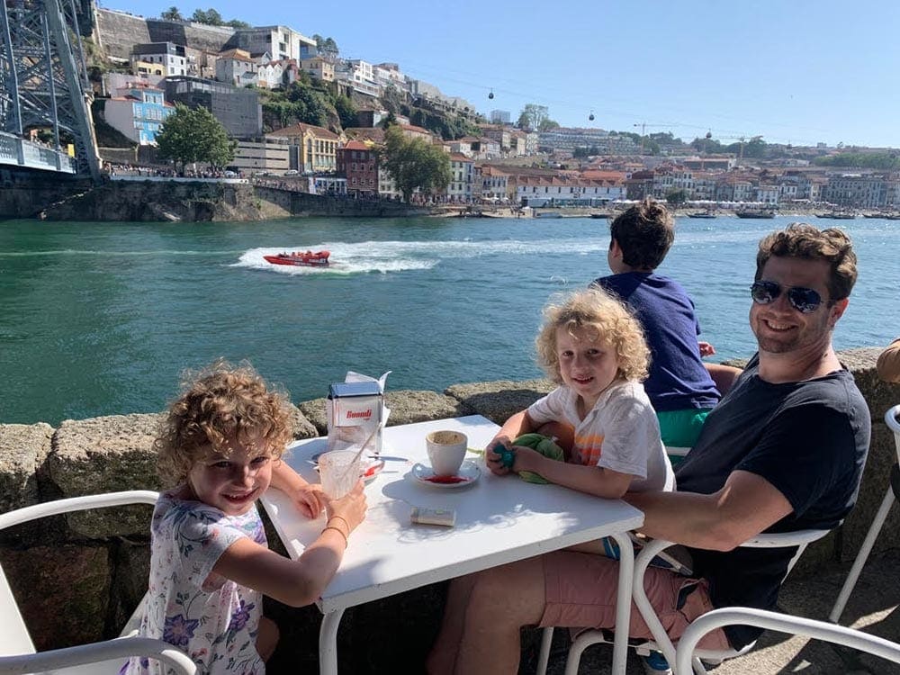 Father with three kids outdoor dining on water in Porto