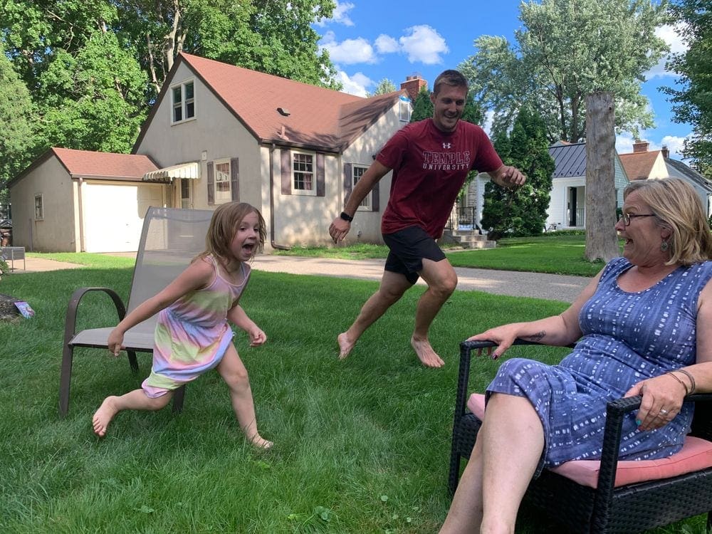 Photo Courtesy: A young girl chases her uncle in a game of duck, duck, goose as her grandma looks on laughing. Playing games is a great way to recharge your batteries as a family.