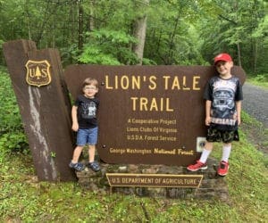 Kids standing in front of Lion's Tale Trail sign in Virginia