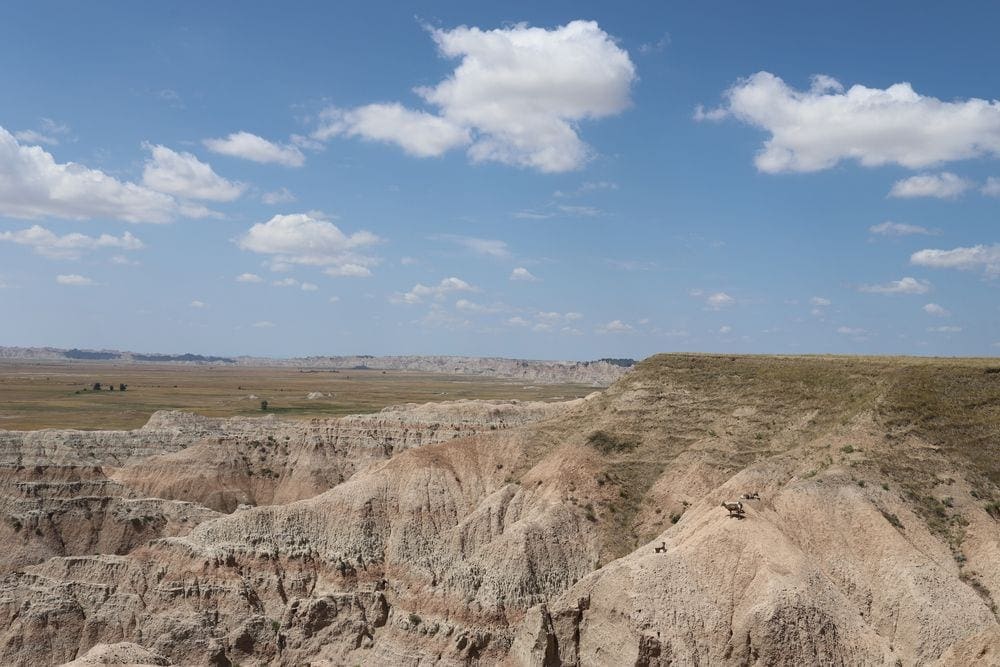 Several large rock formations within the Badlands National Park, a lovely destination for your socially distant vacation with kids.
