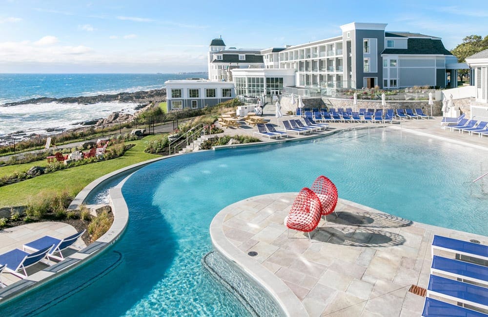 Cliff House's expansive pool, featuring an ocean view and its iconic red chairs.