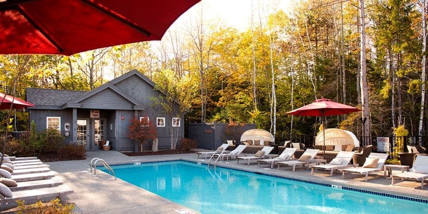 A cozy pool sits on front of a cottage at Hidden Pond, one of the best Maine hotels for families.