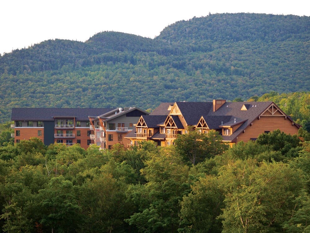 An expansive view of the wooded grounds of the Jay Peak Resort, while the resort is nestled in among the trees.