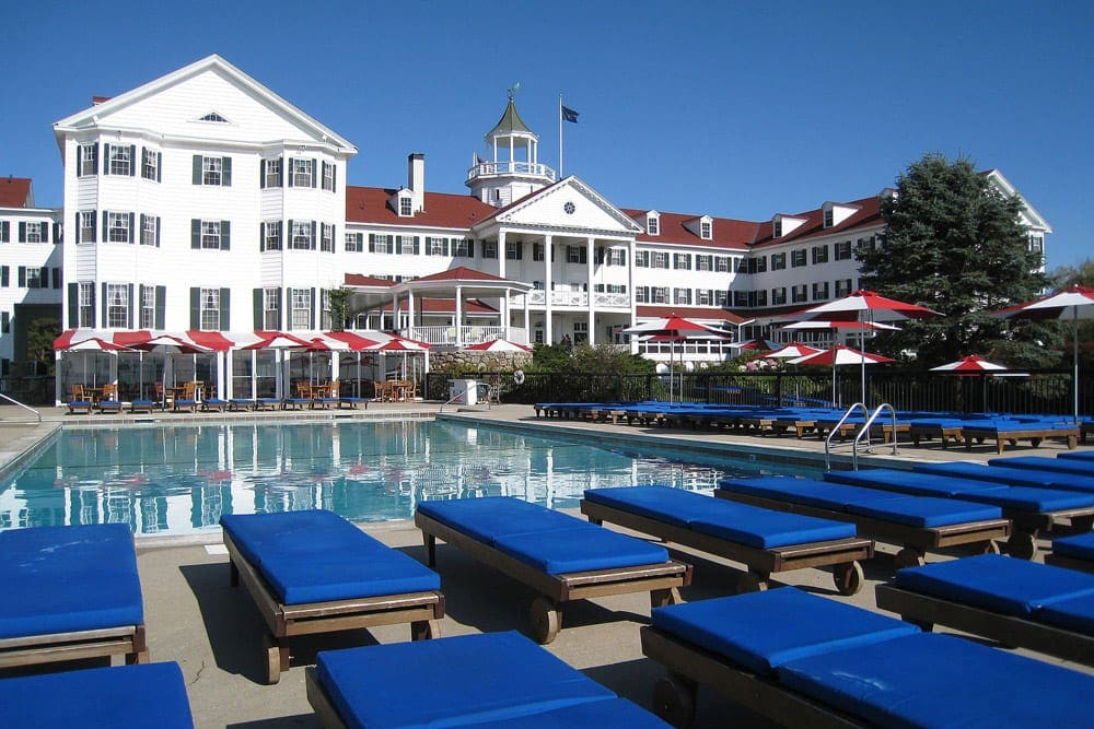 The Colony Hotel stands proudly behind its pristine outdoor pool.