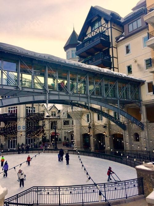 A view of Alderhof Ice Rink in Vail, featuring a number of skaters and dazzling lights.
