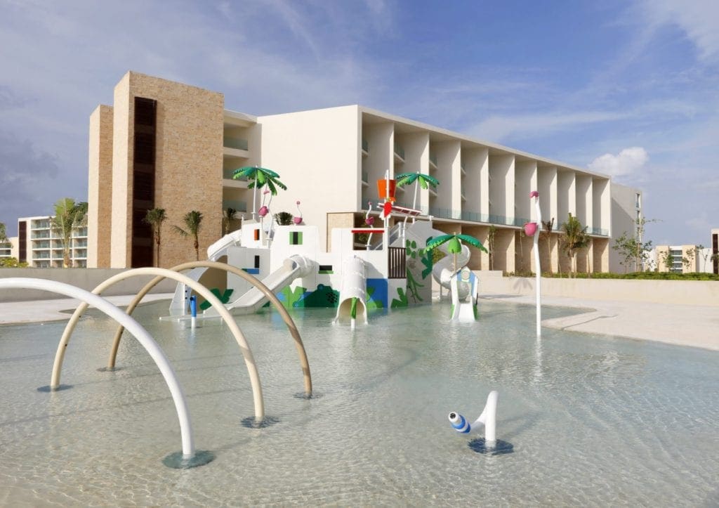 The Grand Palladium Costa Mujeres Resort & Spa stands proudly behind the kids splash pad on-site.