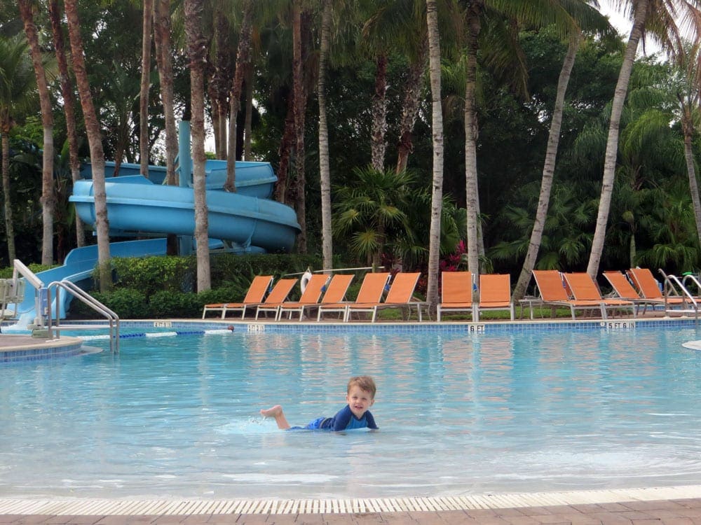 A toddler lays with his tummy in a pool at the Hyatt Regency Cocount Point hotel, one of the best family resorts in Florida.