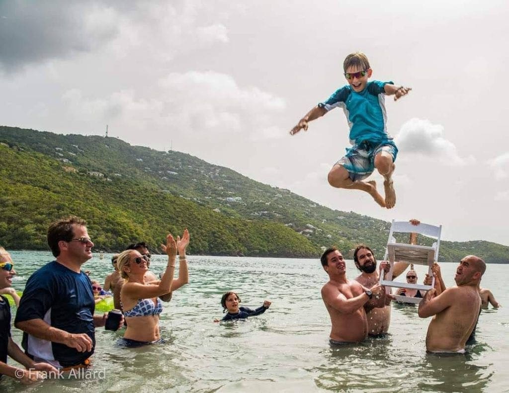 A young Jewish boy is thrown from a chair in the water off the coast of St. Thomas during his Bar Mitzvah.