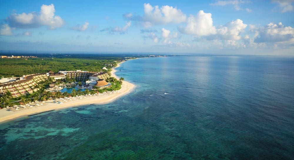 An arieal view of Grand Velas Riviera Maya, one of the best resorts in Mexico for families, featuring an expansive beach and ocean view.